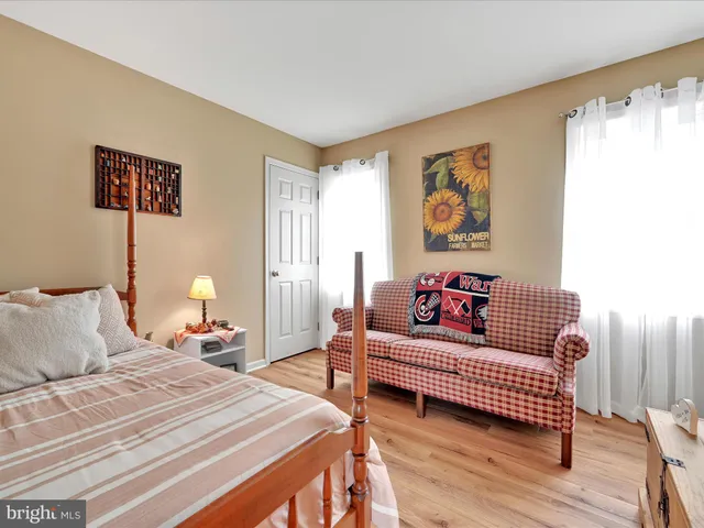 a bedroom with furniture and a window