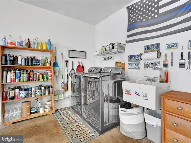 a utility room with lots of clutter and cabinets