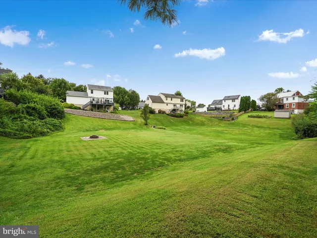 a backyard of a house with a garden and outdoor seating