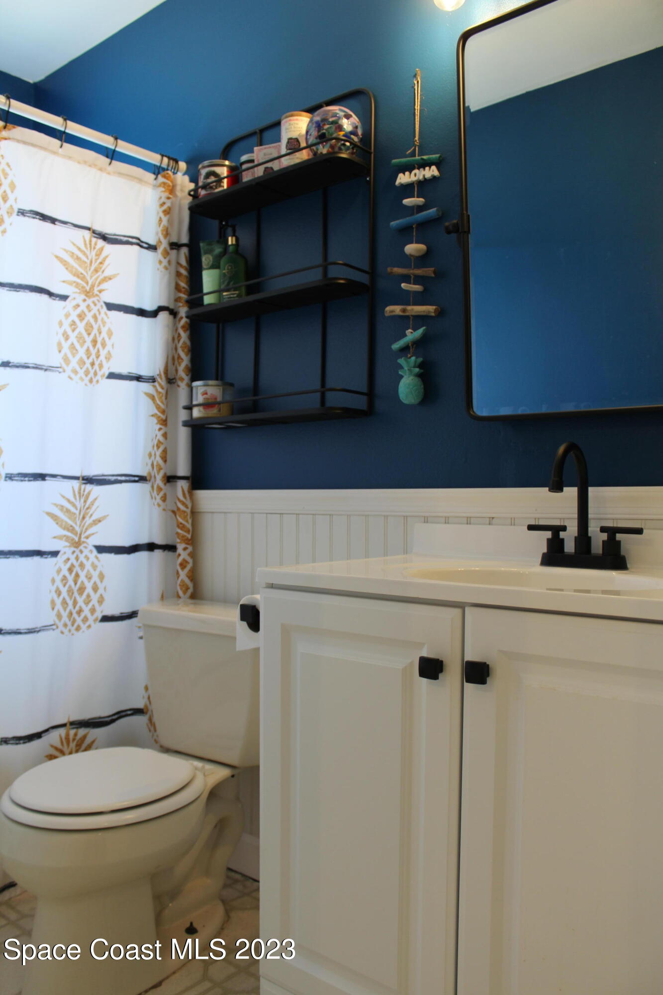 2780 Locksley Road Melbourne, FL 32935 - Photo 18 of 25 a bathroom with a toilet and a sink