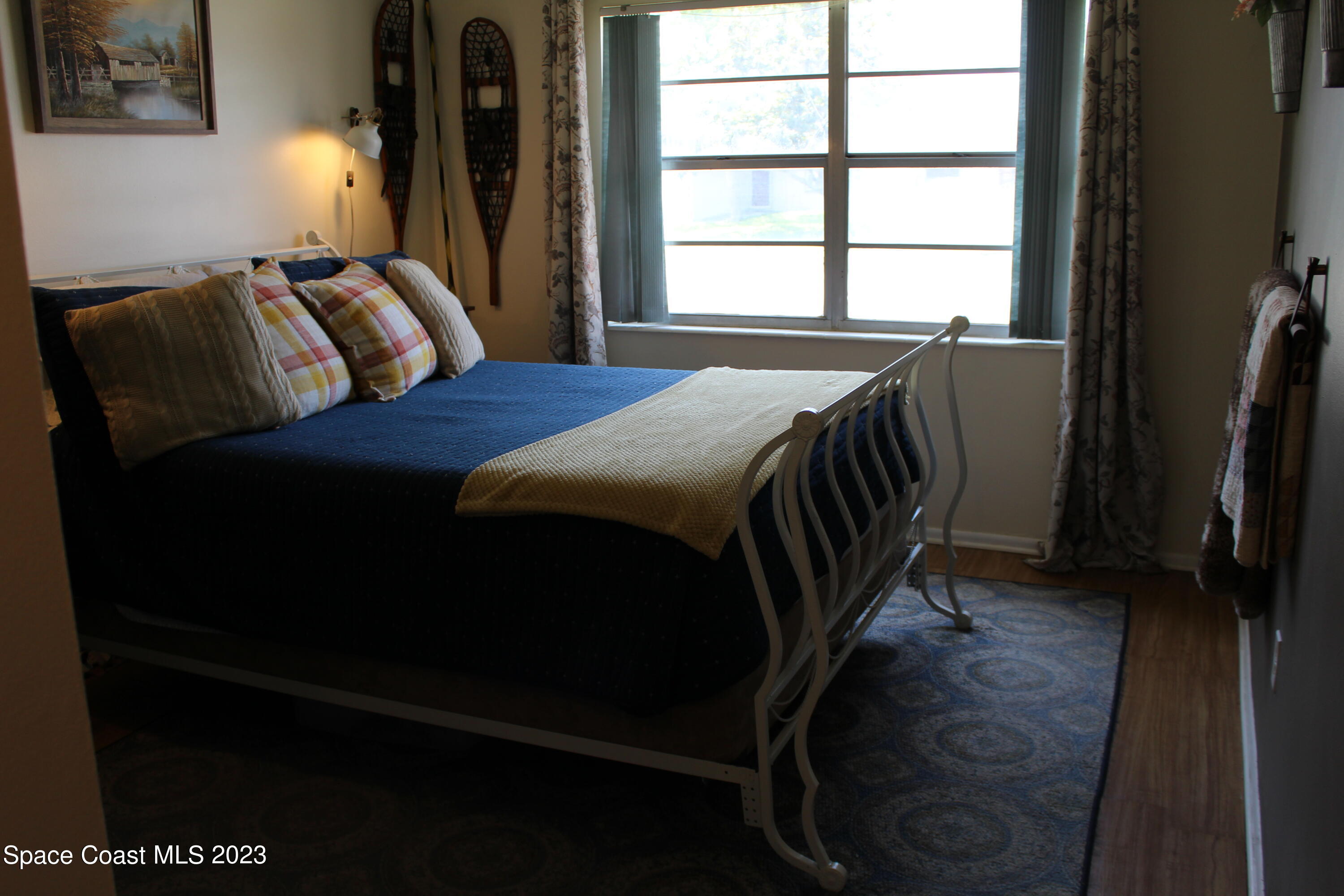 2780 Locksley Road Melbourne, FL 32935 - Photo 23 of 25 a bedroom with a bed a dresser and a window