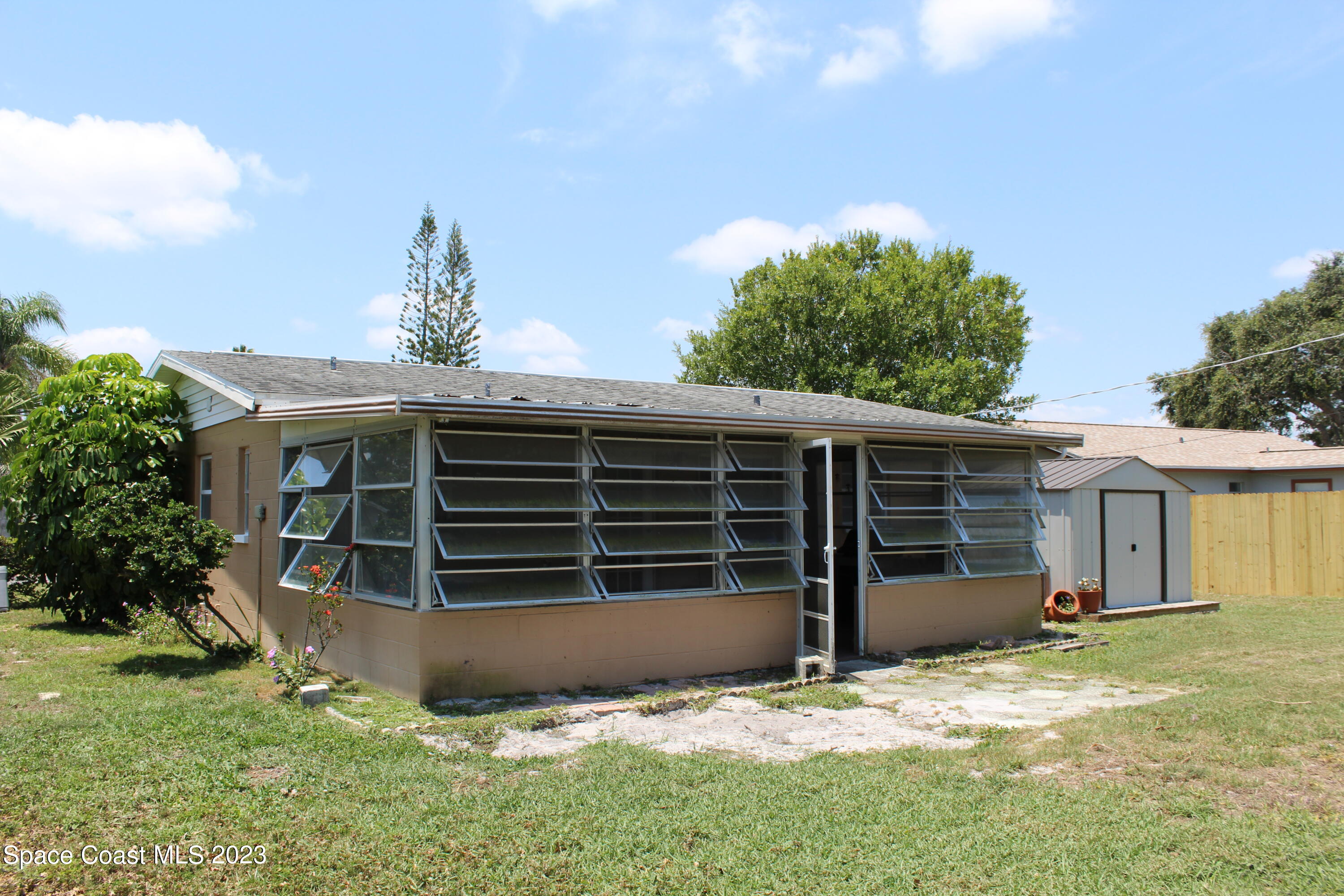 2780 Locksley Road Melbourne, FL 32935 - Photo 8 of 25 a view of a house with a yard and garage