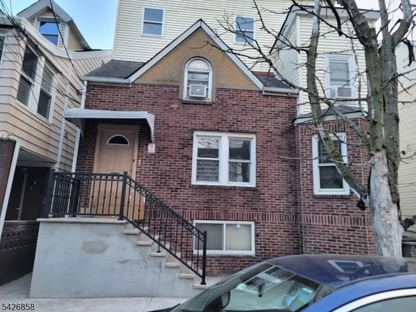 a front view of a house with iron fence