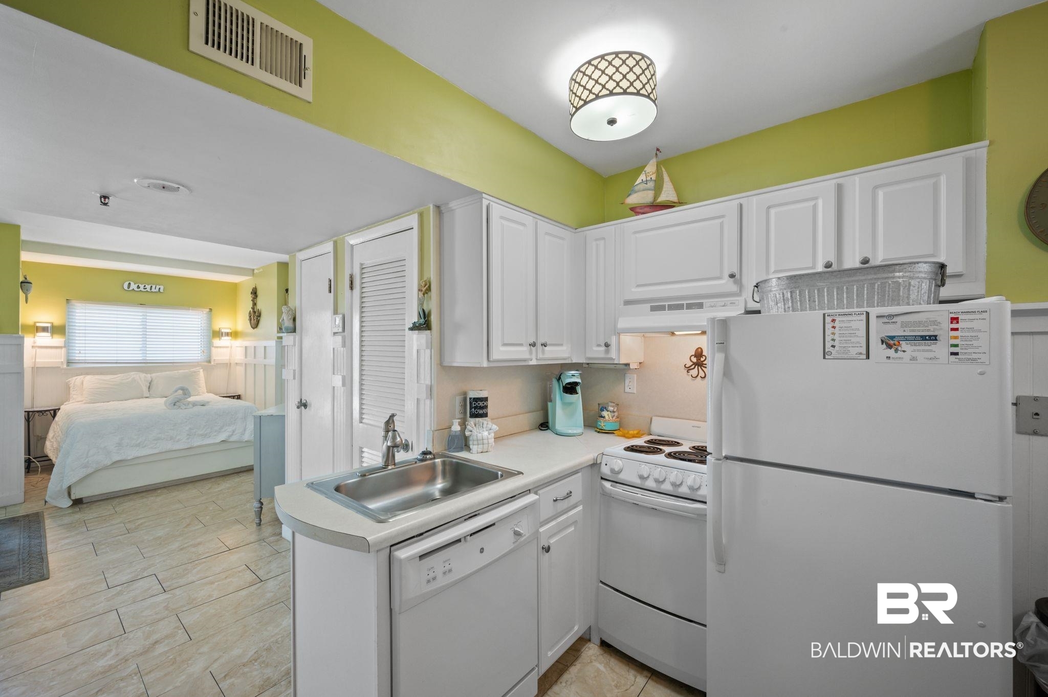 375 Plantation Road, Unit 5304 Gulf Shores, AL 36542 - Photo 14 of 42 Kitchen featuring white appliances, under cabinet range hood, white cabinets, and light countertops