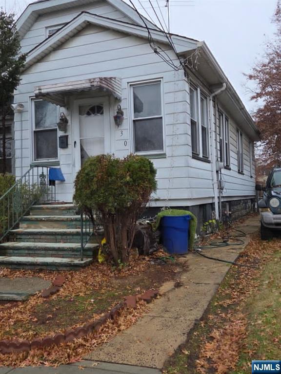 930 Drake Avenue Roselle, NJ 07203 - Photo 2 of 2 a front view of a house with a garden