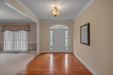 a kitchen with granite countertop cabinets stainless steel appliances and wooden floor