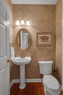 a bathroom with a toilet sink and mirror