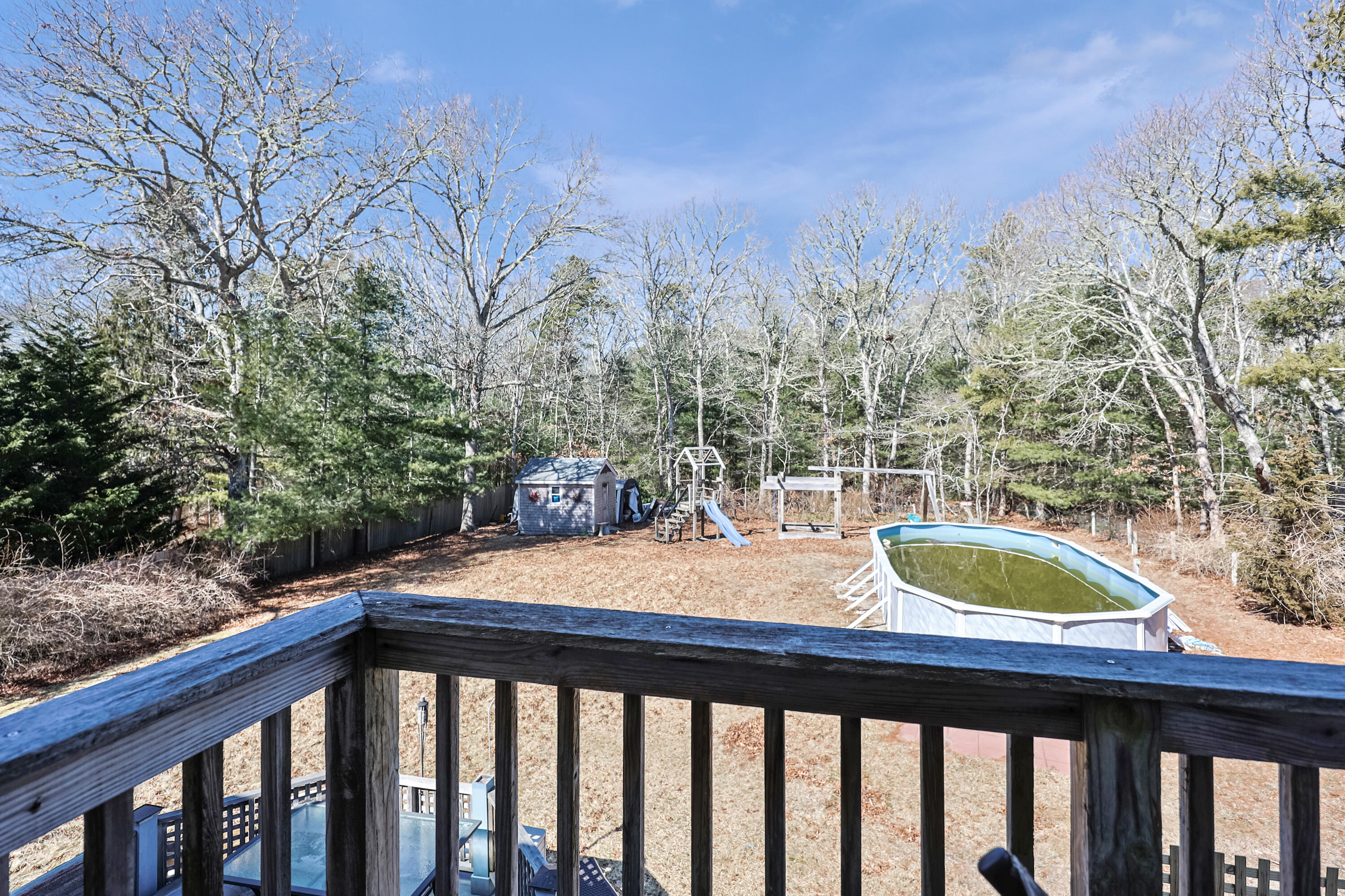 9 Marilyn Road Bourne, MA 02532 - Photo 51 of 54 a view of a wooden balcony with chairs