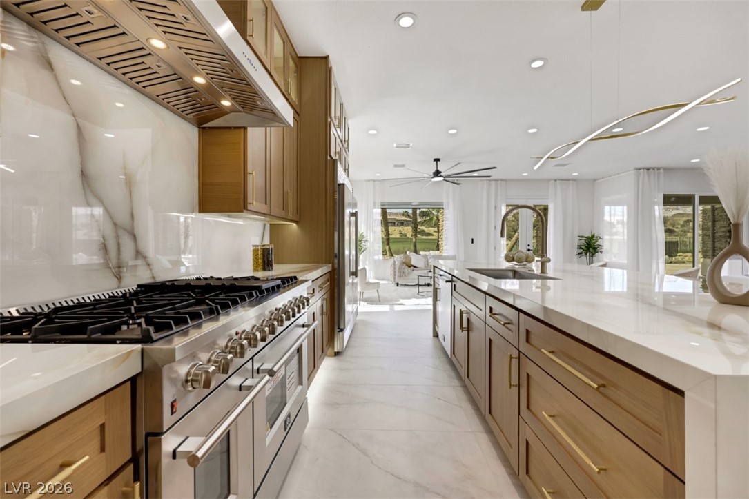 5015 Rivedro Street Las Vegas, NV 89135 - Photo 13 of 91 Culinary aspirations meet luxury in this kitchen, boasting an extended island and high-end range.