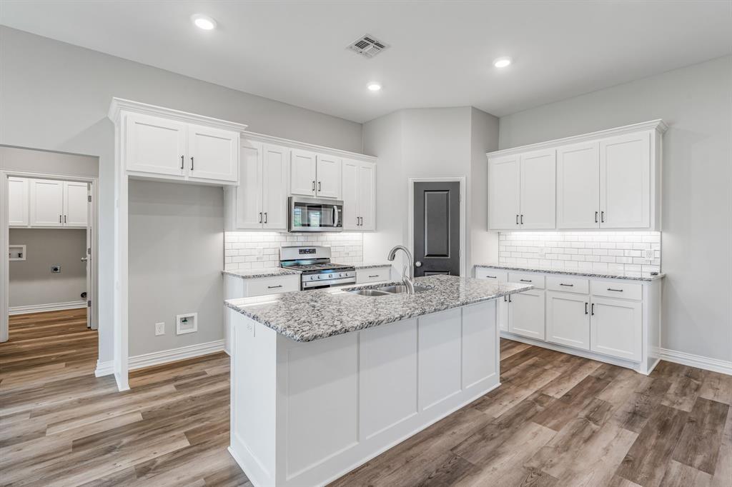 1501 Johnson Road, Unit A Iowa Park, TX 76367 - Photo 11 of 30 a kitchen with a sink stove and refrigerator