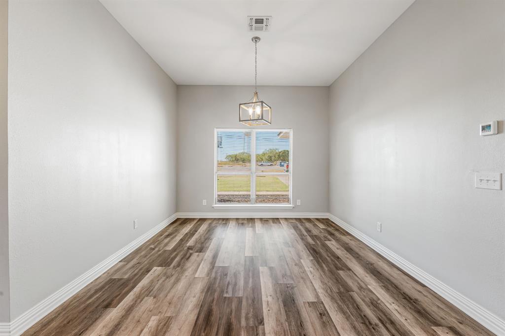 1501 Johnson Road, Unit A Iowa Park, TX 76367 - Photo 13 of 30 a view of room with window hardwood floor and window