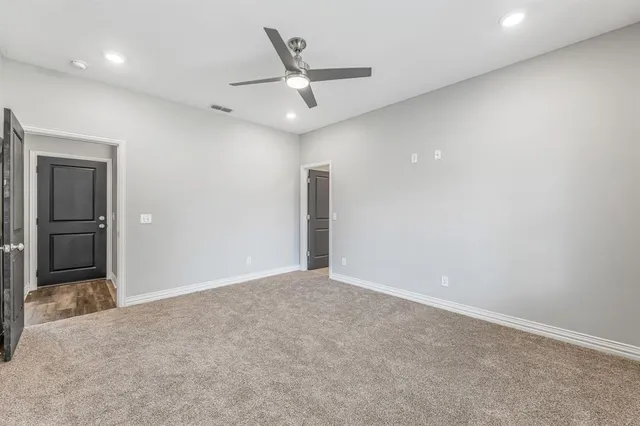 a bathroom with a double vanity sink a toilet and a shower