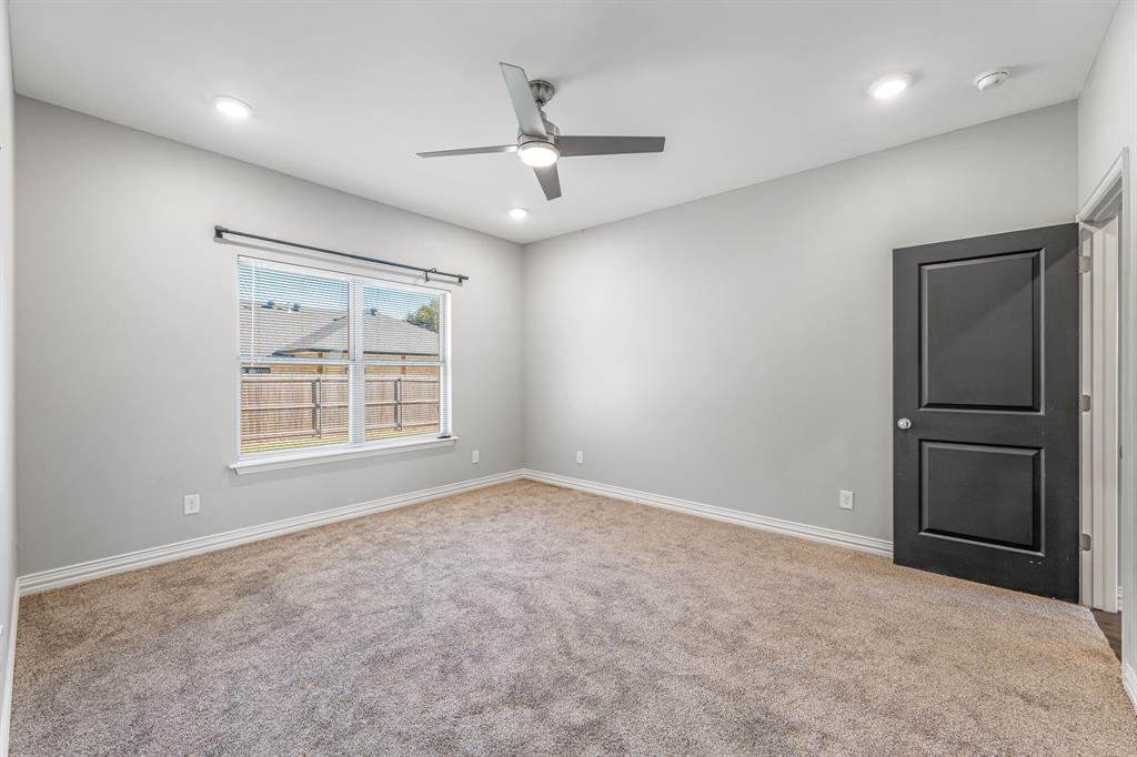 1501 Johnson Road, Unit A Iowa Park, TX 76367 - Photo 18 of 30 an empty room with windows and closet