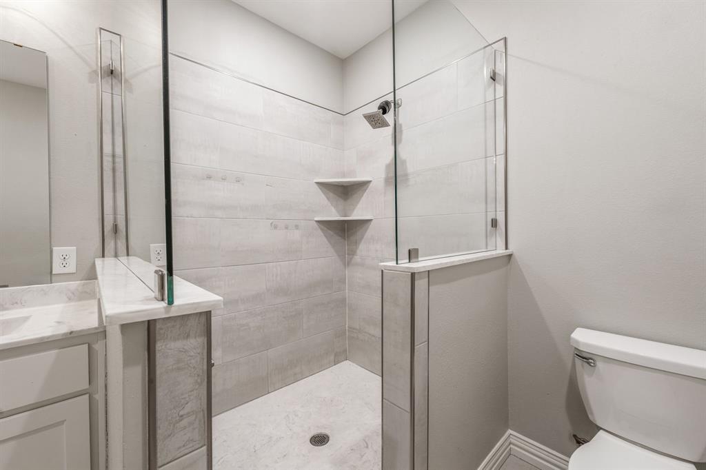 1501 Johnson Road, Unit A Iowa Park, TX 76367 - Photo 20 of 30 a bathroom with a granite countertop sink toilet and shower