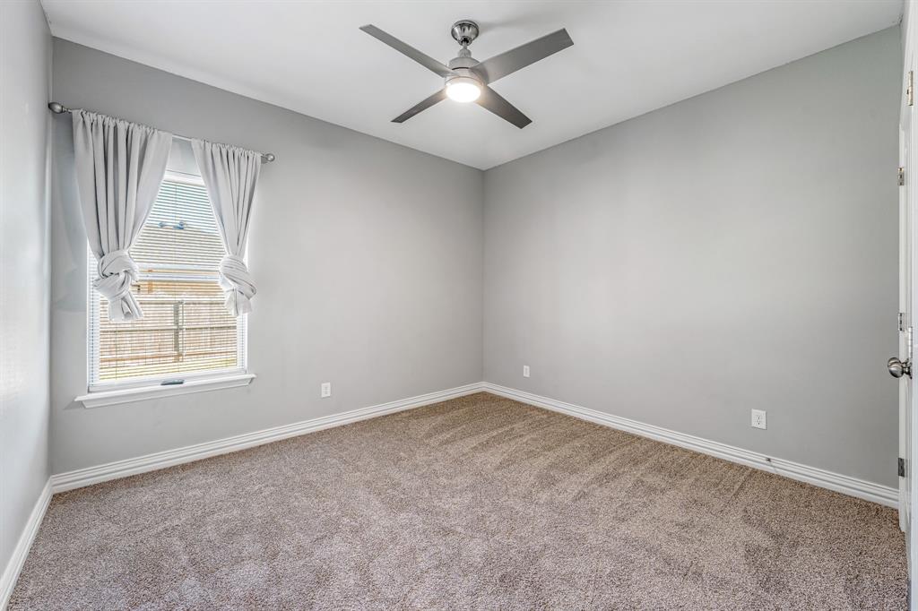 1501 Johnson Road, Unit A Iowa Park, TX 76367 - Photo 26 of 30 an empty room with windows and fan