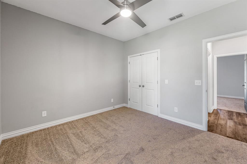 1501 Johnson Road, Unit A Iowa Park, TX 76367 - Photo 27 of 30 an empty room with chandelier fan and windows