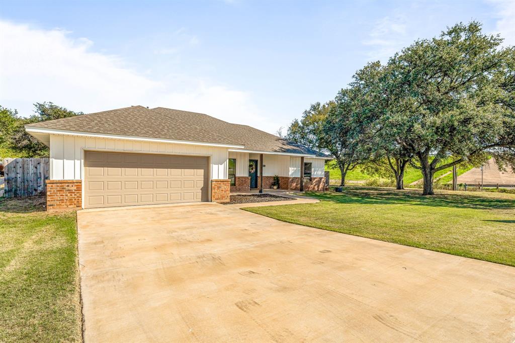 1501 Johnson Road, Unit A Iowa Park, TX 76367 - Photo 4 of 30 a front view of house with yard and trees