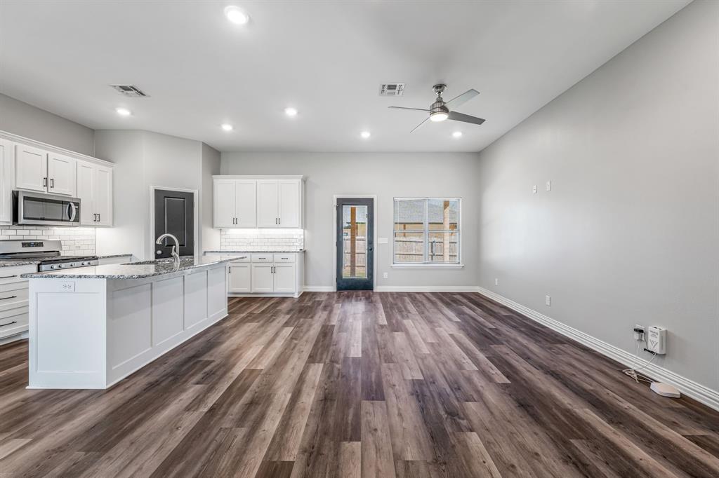 1501 Johnson Road, Unit A Iowa Park, TX 76367 - Photo 6 of 30 a view of kitchen with sink microwave refrigerator and cabinets