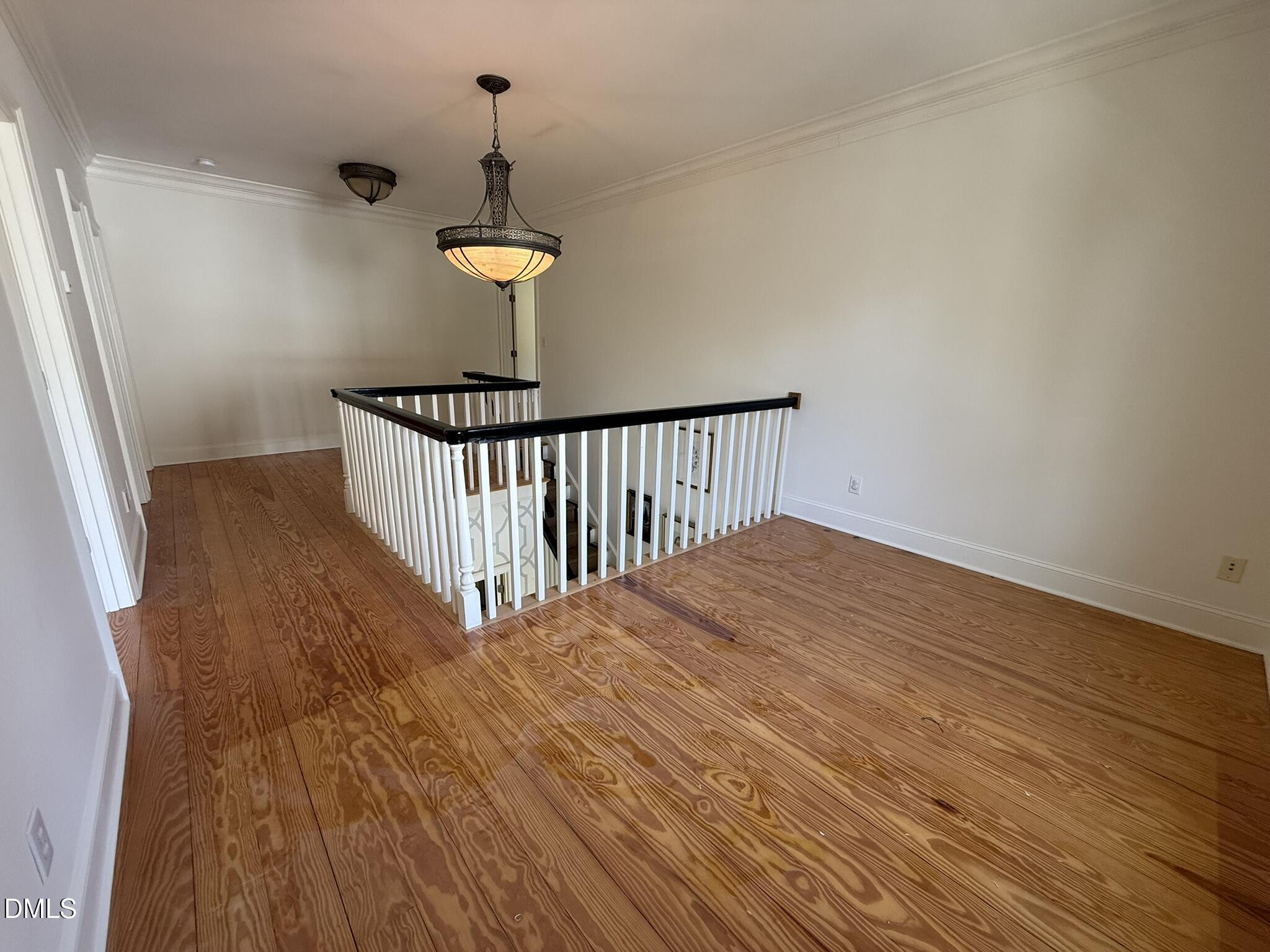 3617 Carlow Court Raleigh, NC 27612 - Photo 15 of 30 a view of a hallway with wooden floor and staircase