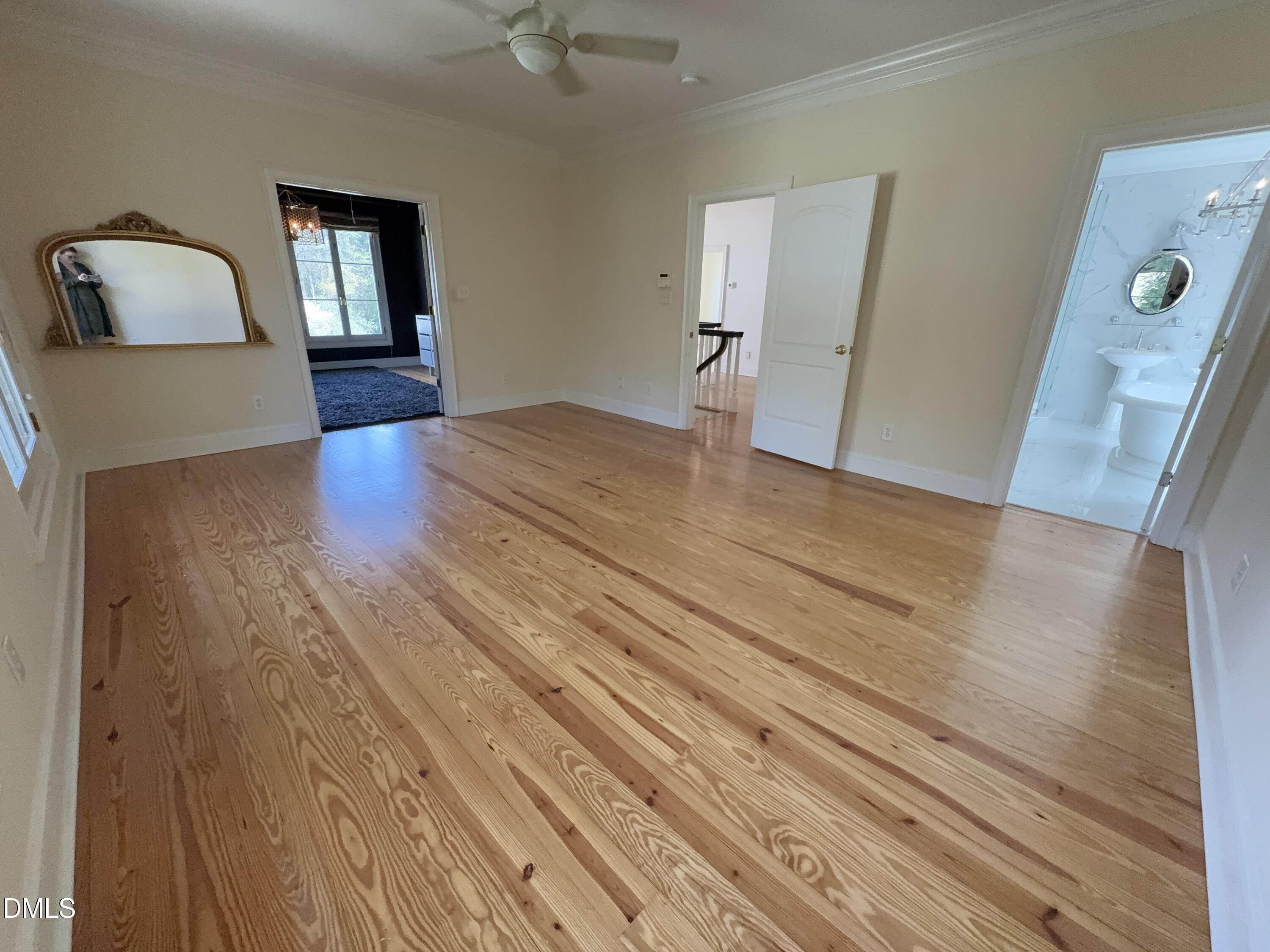 3617 Carlow Court Raleigh, NC 27612 - Photo 16 of 30 a bedroom with a bed and wooden floor