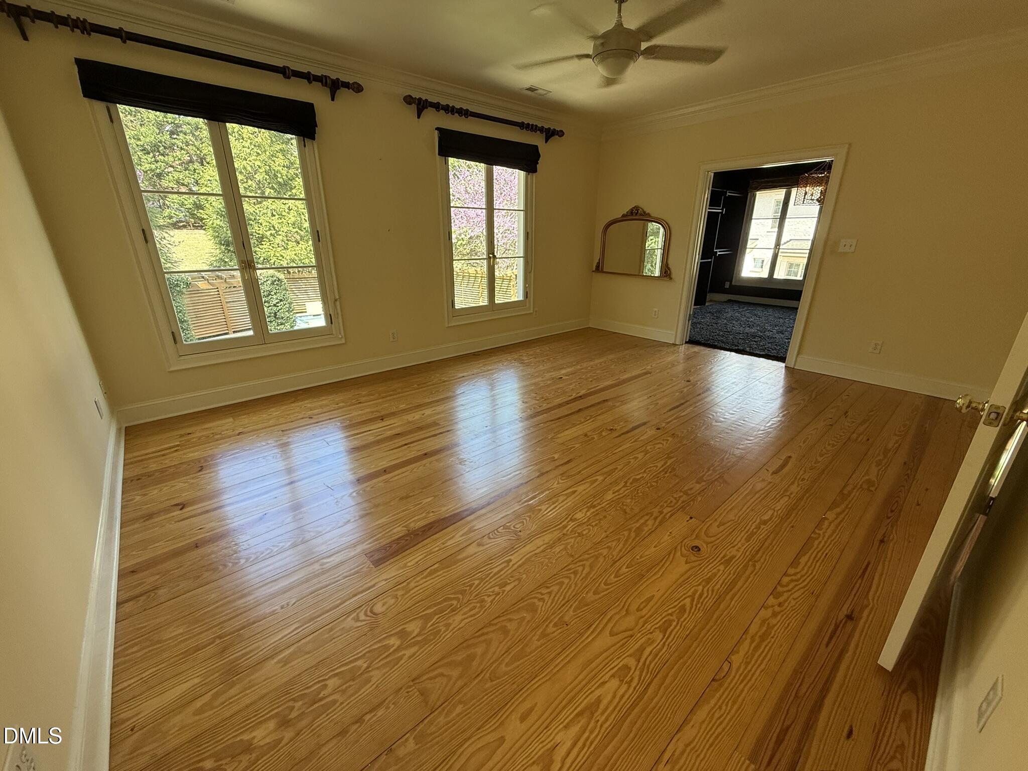 3617 Carlow Court Raleigh, NC 27612 - Photo 17 of 30 a view of empty room with wooden floor and fan