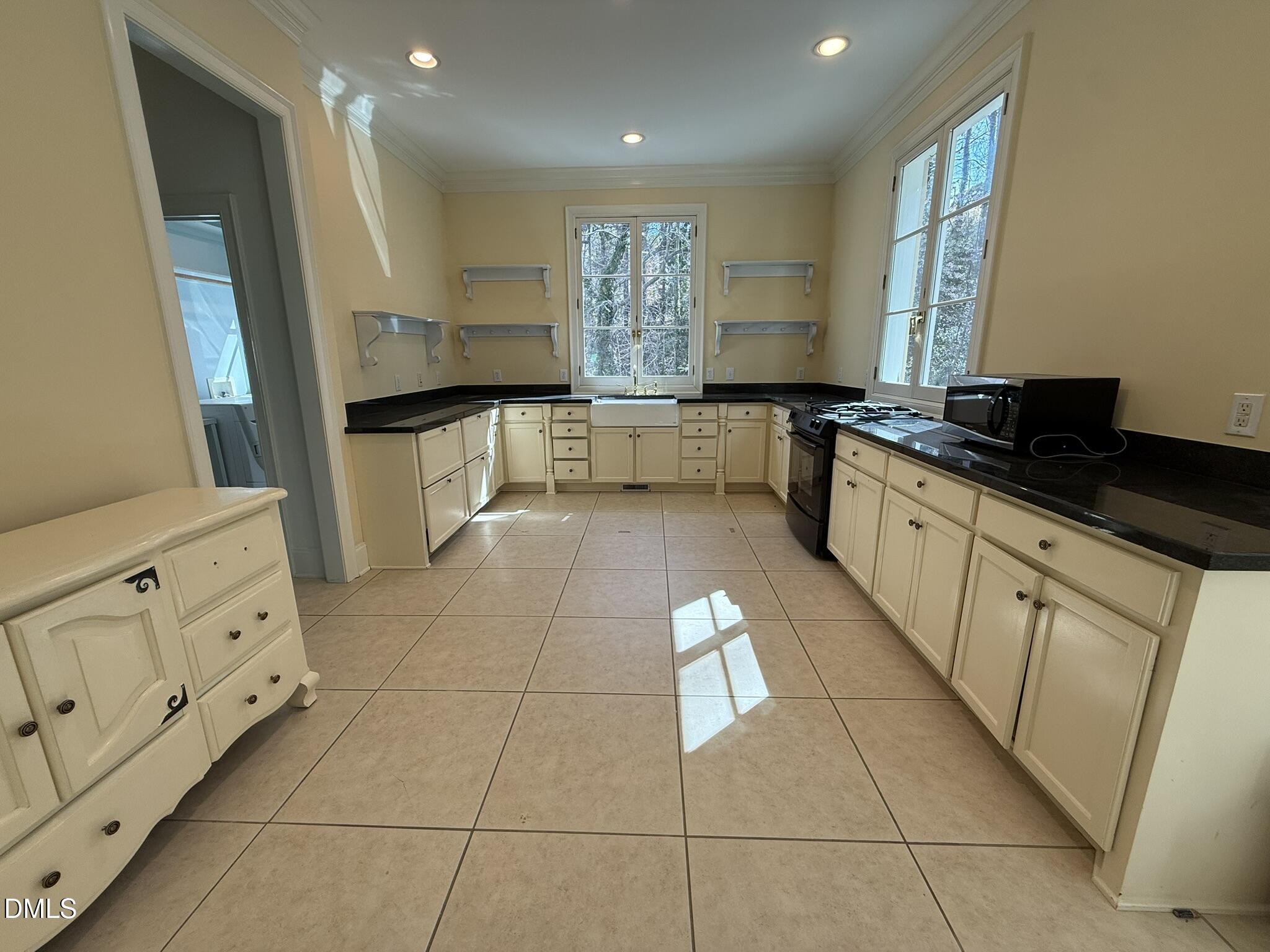 3617 Carlow Court Raleigh, NC 27612 - Photo 6 of 30 a large kitchen with stainless steel appliances a stove a sink and a refrigerator