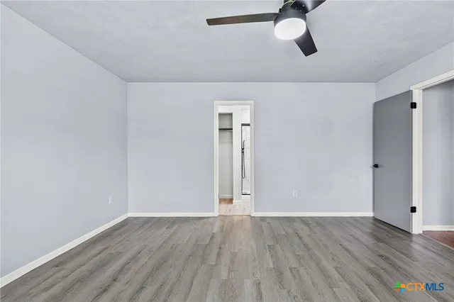 a view of a room with wooden floor ceiling fan