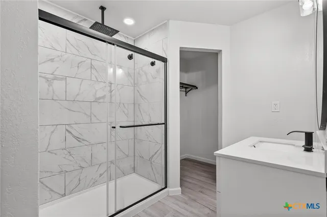 a bathroom with a bathtub and shower
