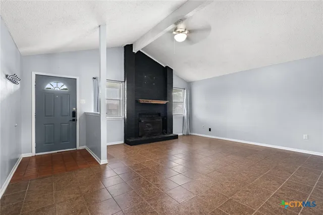 a view of an empty room with a fireplace