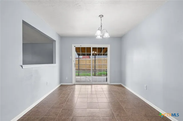 a view of an empty room with windows