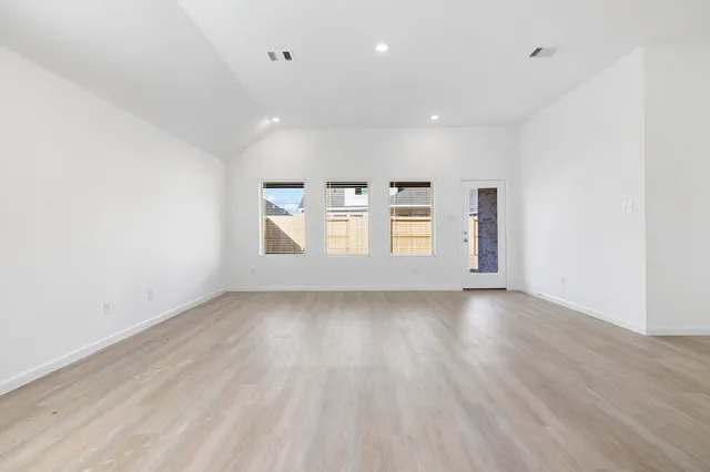 a view of a kitchen with wooden floor and window