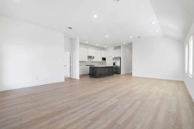a view of a kitchen with a sink and a refrigerator