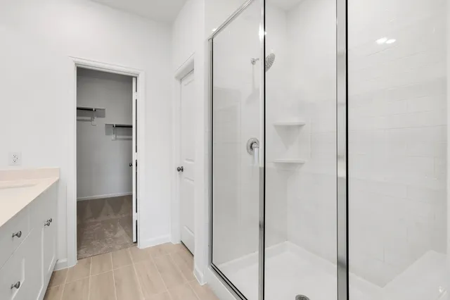 a bathroom with a shower and a sink