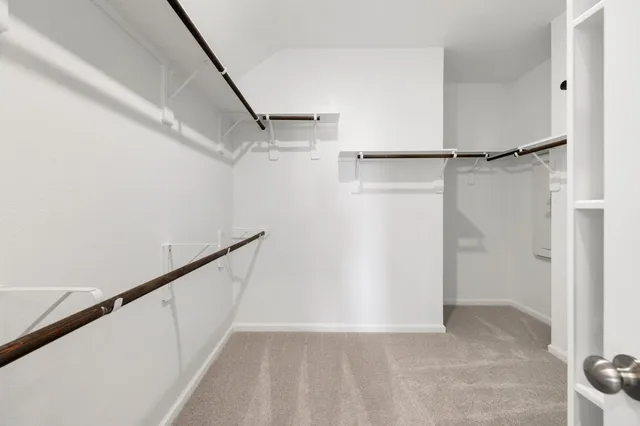 a view of an empty walk in closet with empty racks