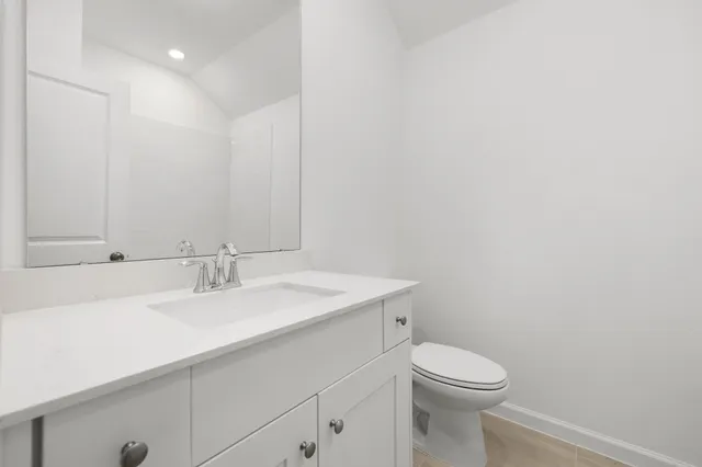 a bathroom with a sink a toilet and mirror