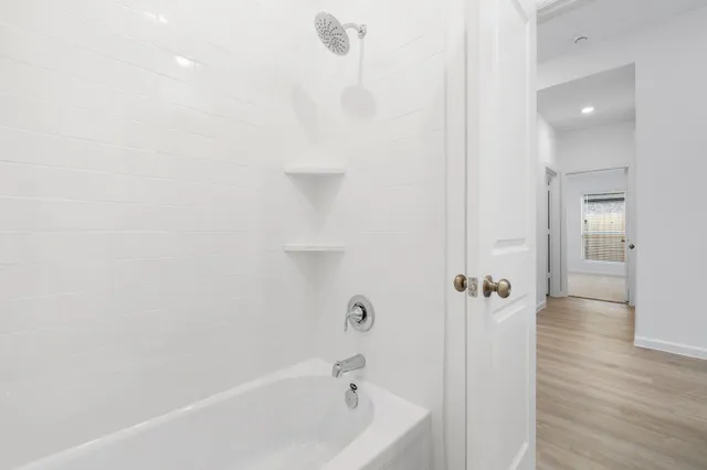 a bathroom with a bathtub and a shower