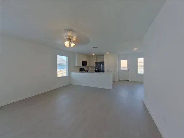 a view of a big room with windows and cabinet