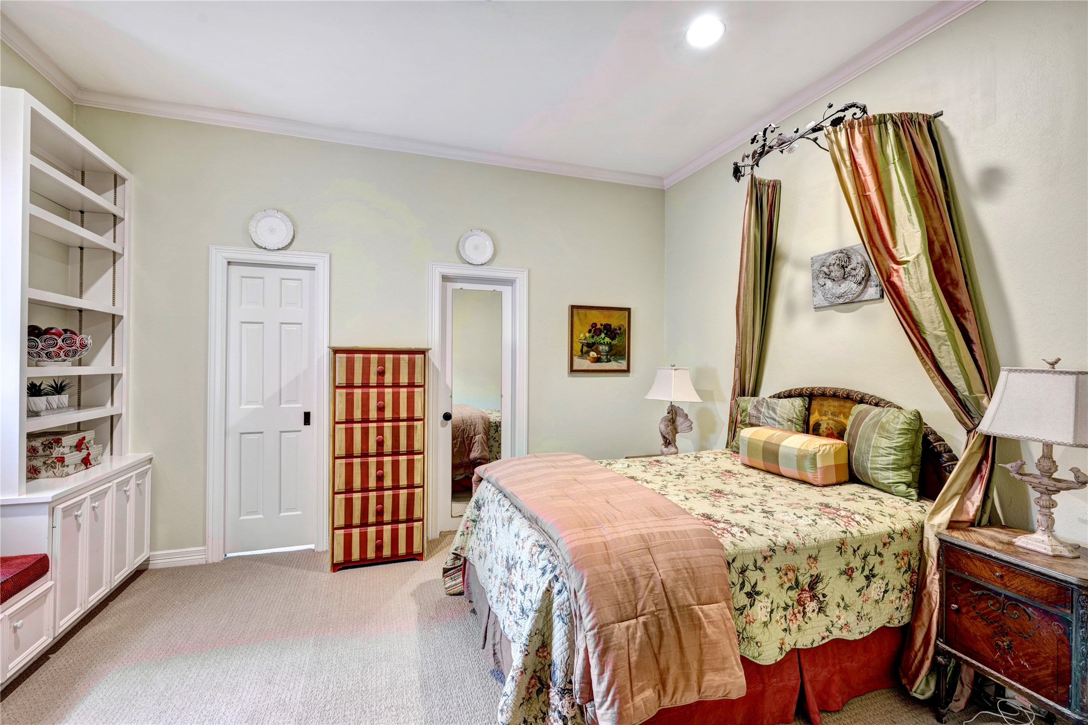 3744 Inwood Drive Houston, TX 77019 - Photo 27 of 32 a bedroom with a bed and a book shelf
