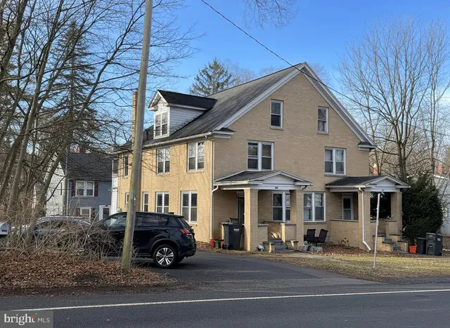 a view of a car parked in front of a house