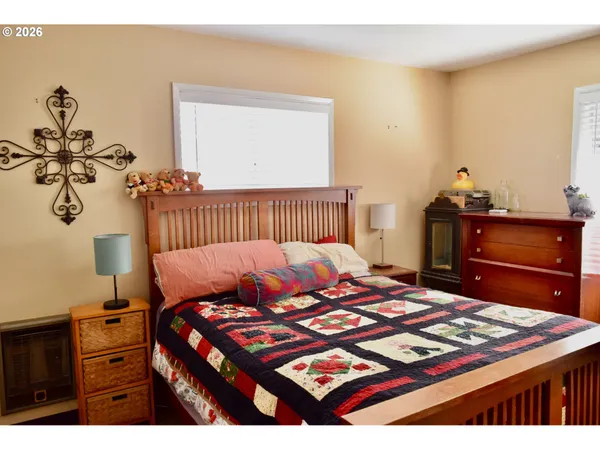 a bedroom with a bed and dresser