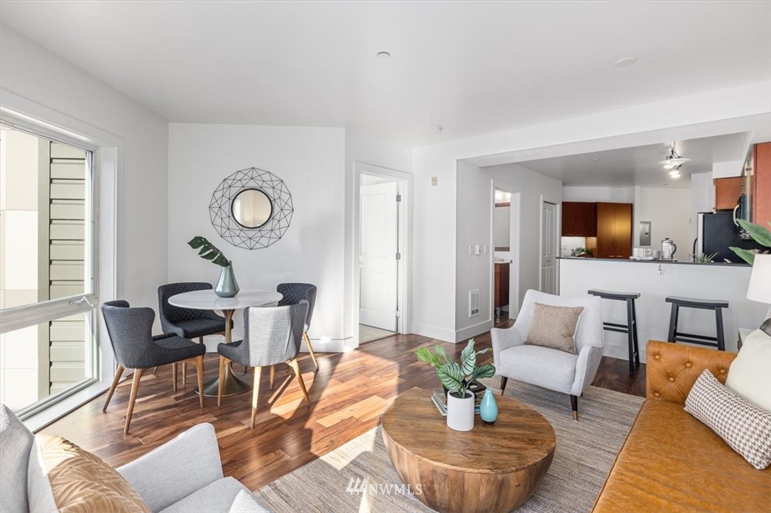 159 Denny Way, Unit 313 Seattle, WA 98109 - Photo 1 of 32 a living room with furniture and a large window