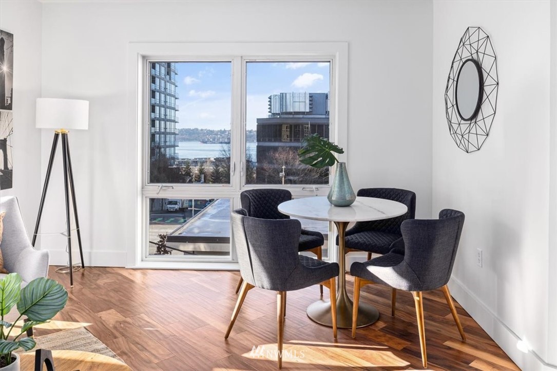 159 Denny Way, Unit 313 Seattle, WA 98109 - Photo 13 of 32 a dining room with furniture and window