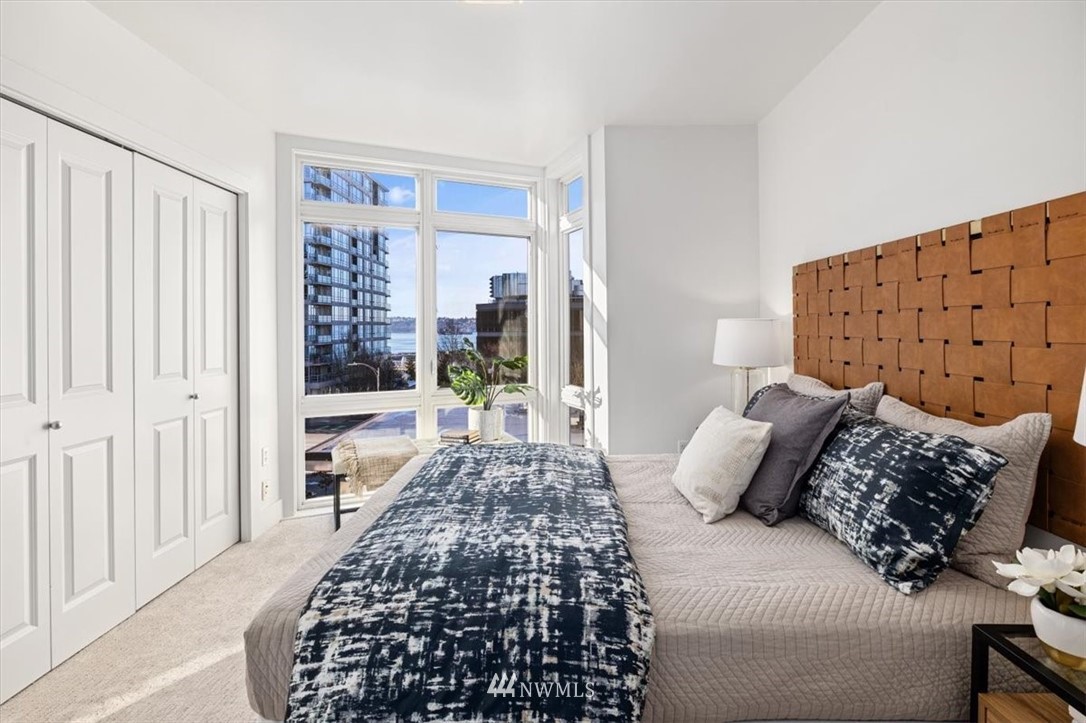 159 Denny Way, Unit 313 Seattle, WA 98109 - Photo 16 of 32 a bedroom with a bed and a window