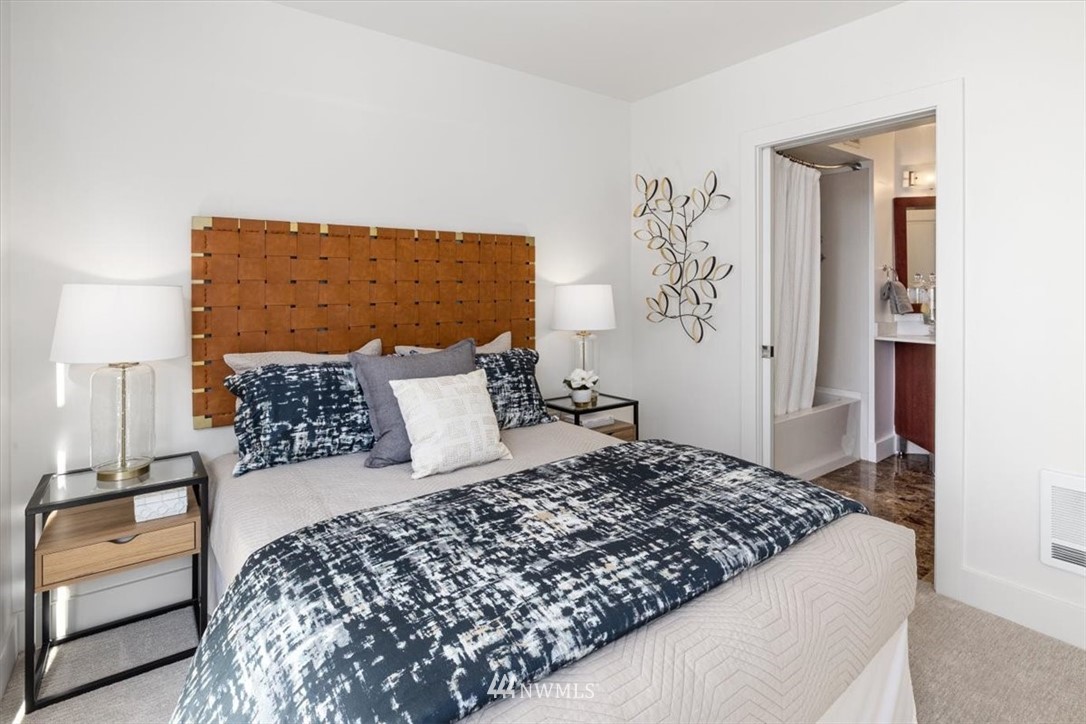 159 Denny Way, Unit 313 Seattle, WA 98109 - Photo 18 of 32 a bedroom with a bed and a couch