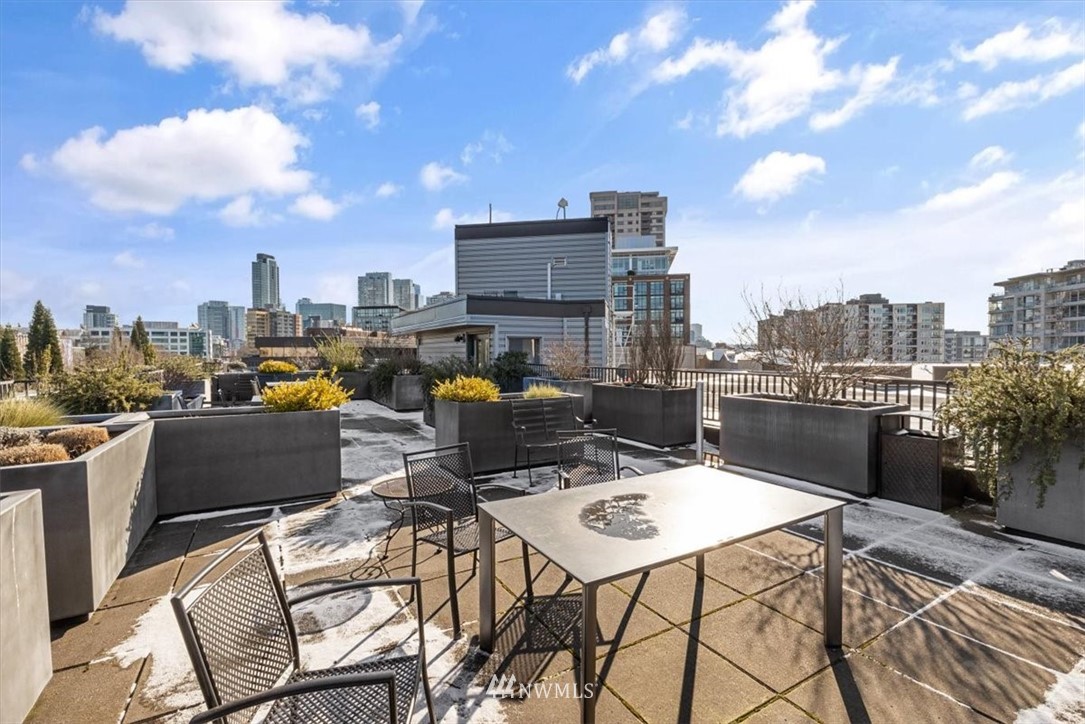 159 Denny Way, Unit 313 Seattle, WA 98109 - Photo 26 of 32 a view of a terrace with furniture and stove