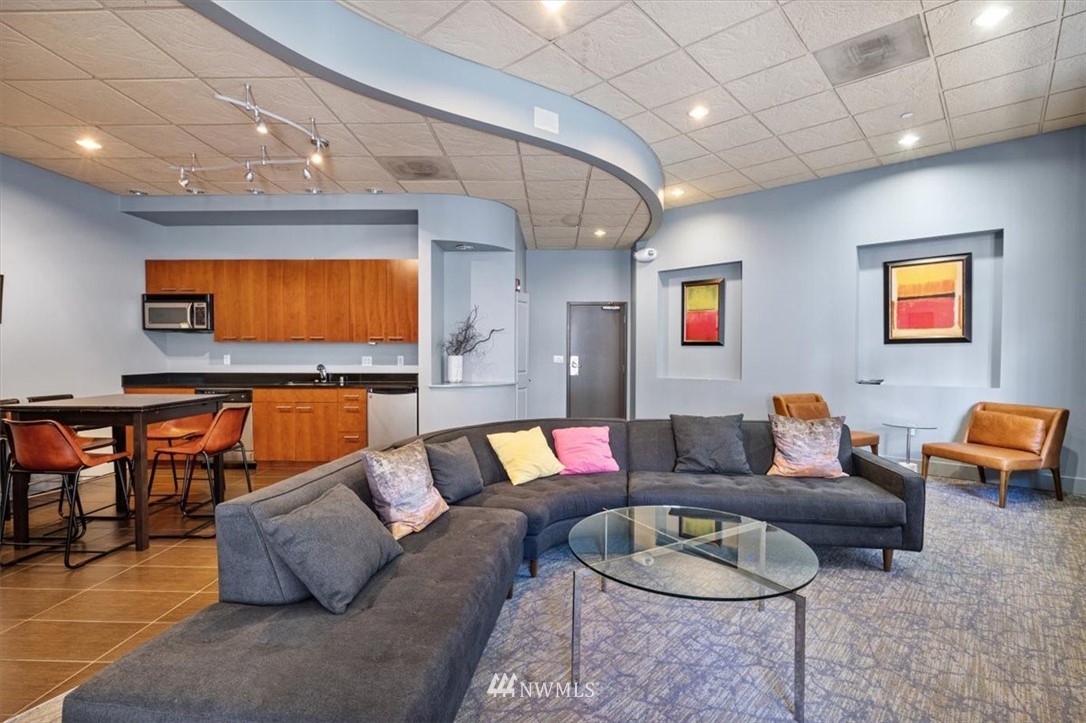 159 Denny Way, Unit 313 Seattle, WA 98109 - Photo 29 of 32 a living room with furniture and a flat screen tv