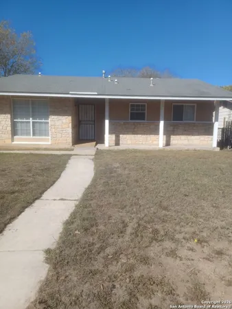 front view of a house with a yard and a garage