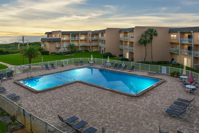 a view of a swimming pool with a yard