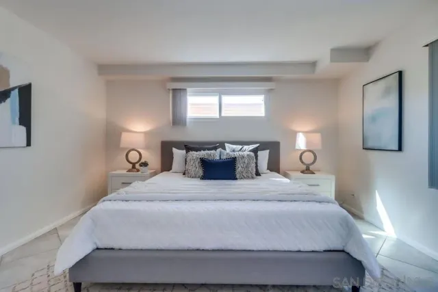 a bedroom with a bed and window