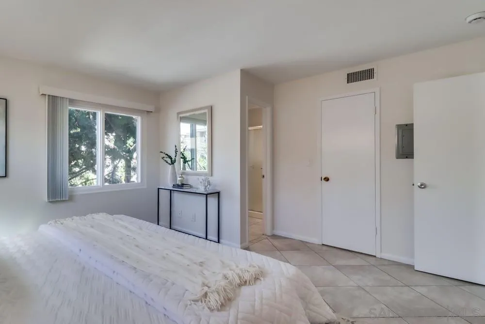 2244 2nd Avenue, Unit 25 San Diego, CA 92101 - Photo 14 of 27 a large bedroom with a bed and a window